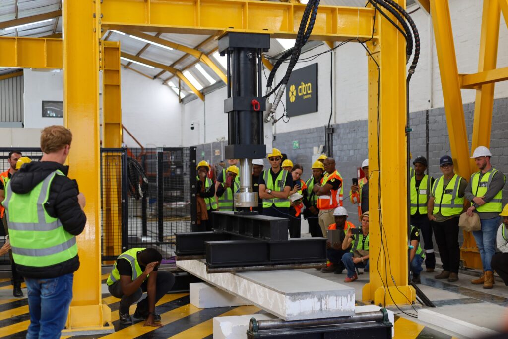 The Citra team observes a structural performance test during a tour of the new Citra Laboratory.