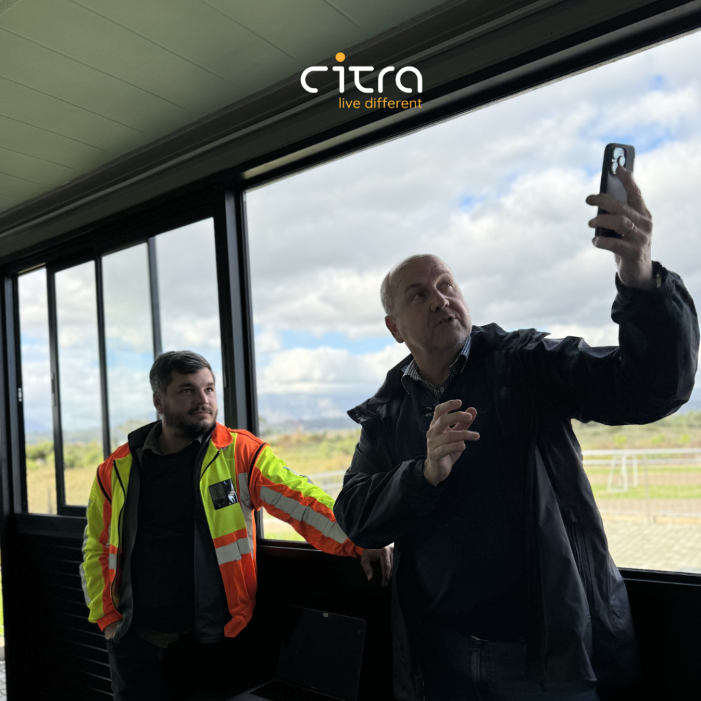 Citra Head of Construction watching the Open Space AI trainer demonstrate how Open Space field Notes work.