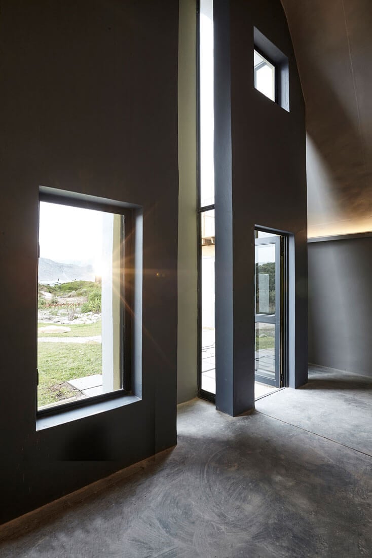 Contemporary interior with large windows and minimalist architecture.