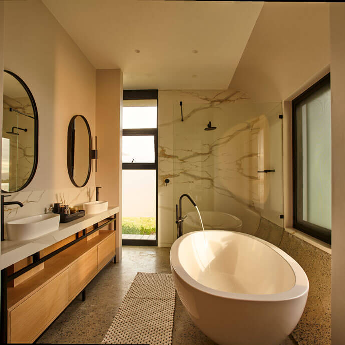 ePod Luxury bathroom with freestanding bathtub and double vanity, featuring modern design and natural lig.