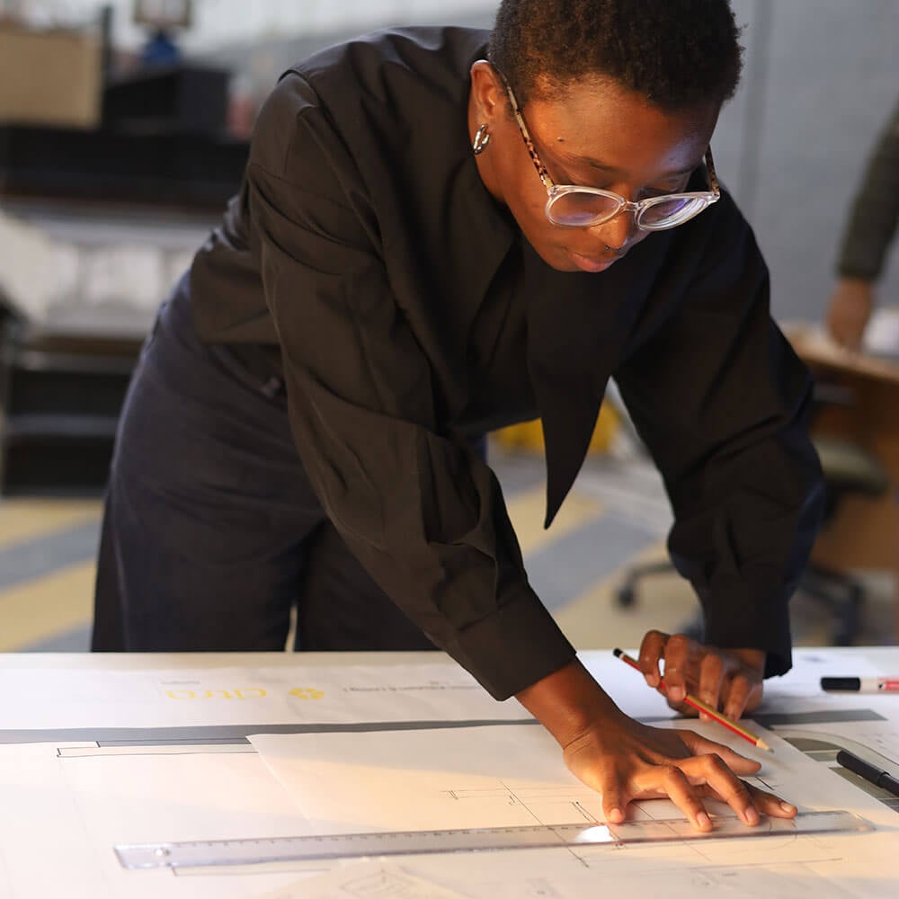 Woman working on architectural design project at Citra build workshop.