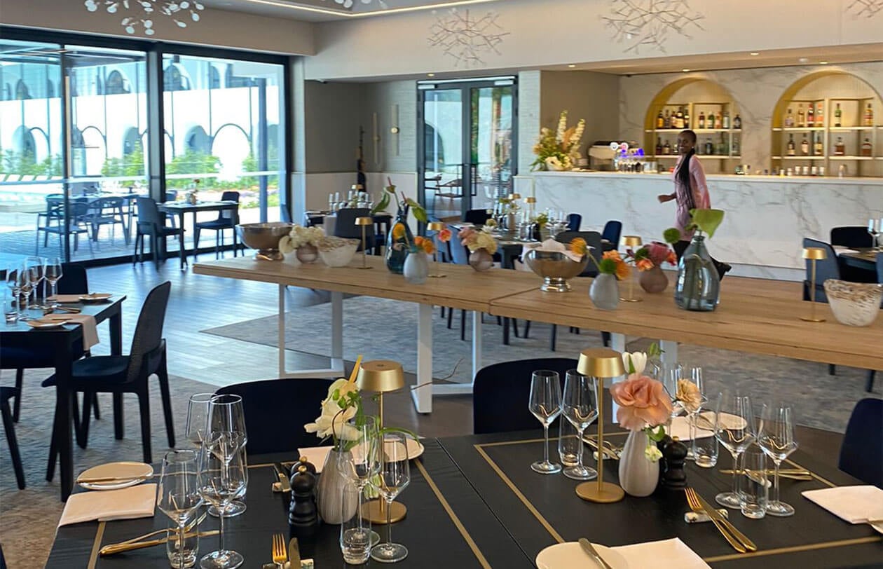 Upscale dining space featuring stylish table arrangements and contemporary design elements.