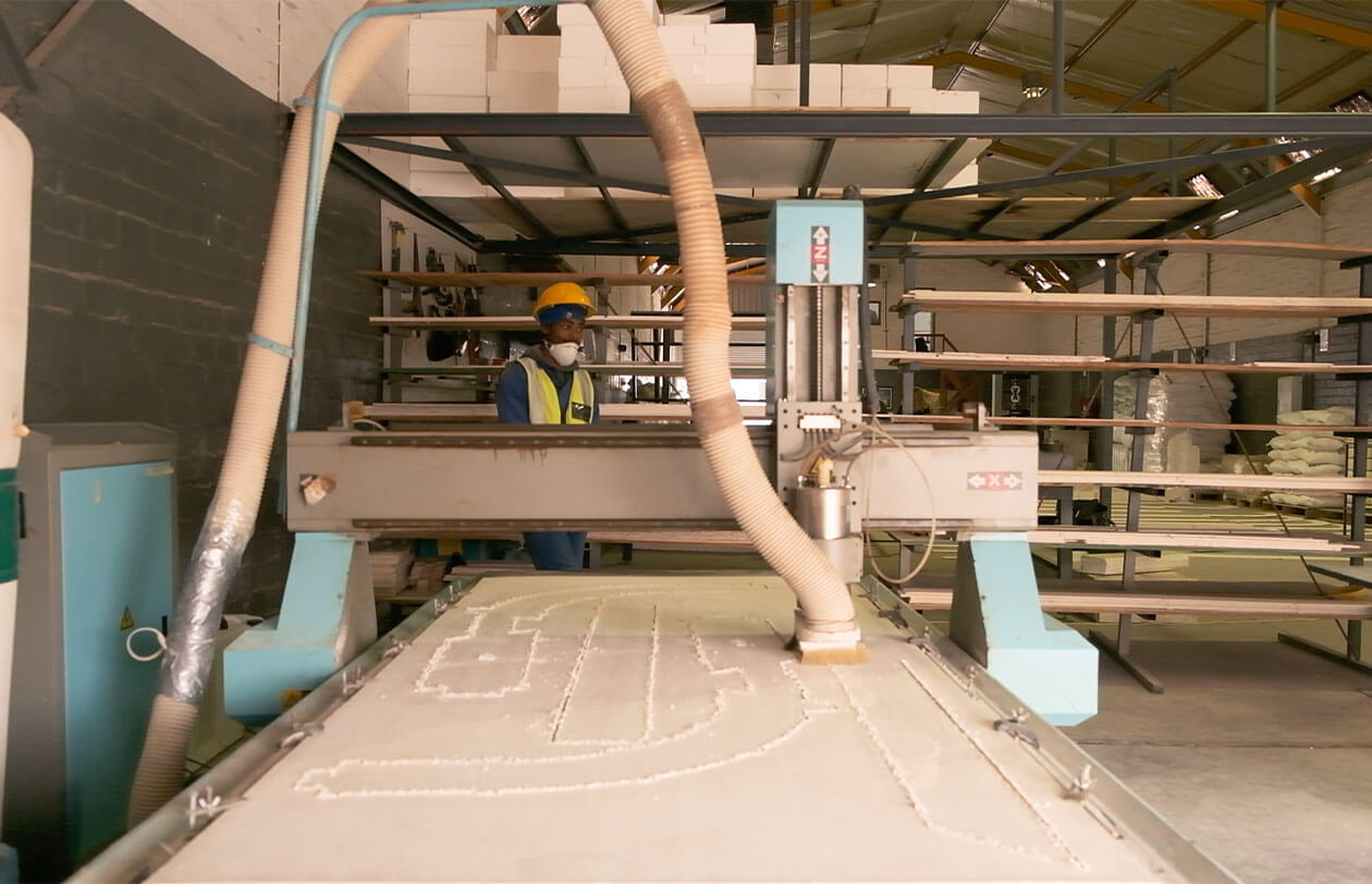 Deep Dive Industrial manufacturing process at Citra with machinery and worker in safety gear.
